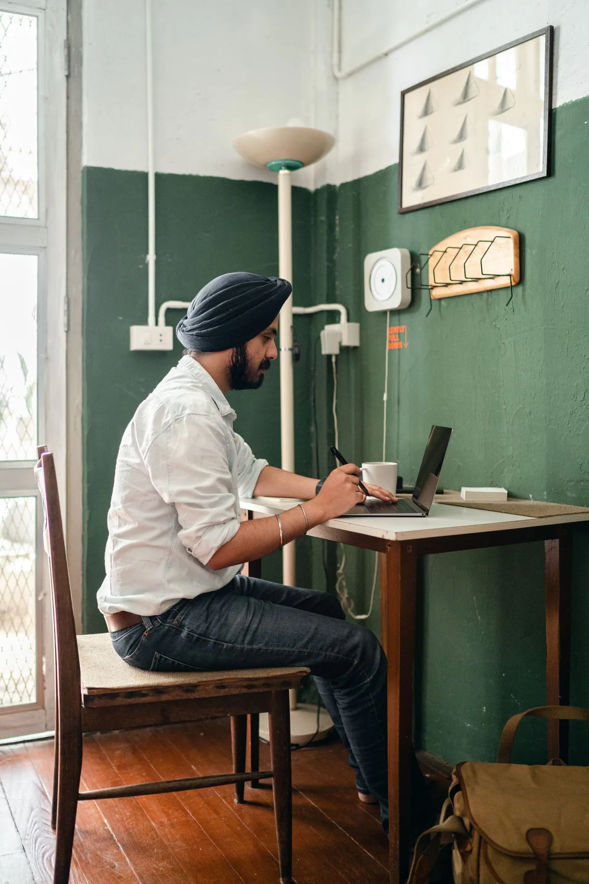 Indian professional using a laptop in a modern workplace