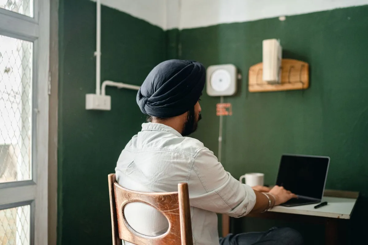 Indian professional working on a laptop at home