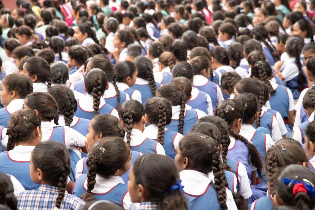 Group of Indian schoolgirls in blue uniforms at school